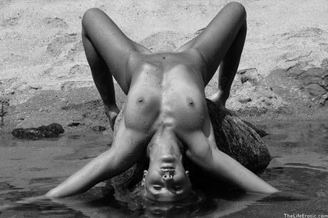 Blonde teen Ameli poses totally naked in a tidal pool during solo action