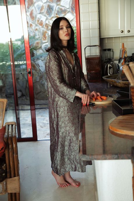 Stunning teen Malena removes her dress to pose nude in the kitchen