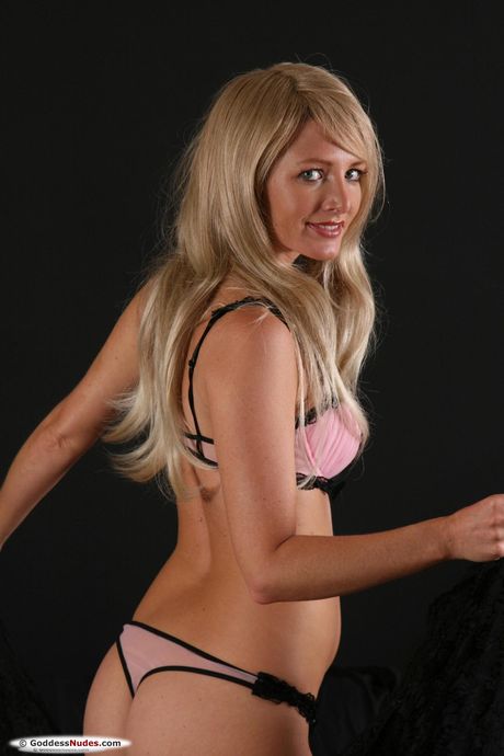 Blonde teen with small tits and a nice ass models in the nude