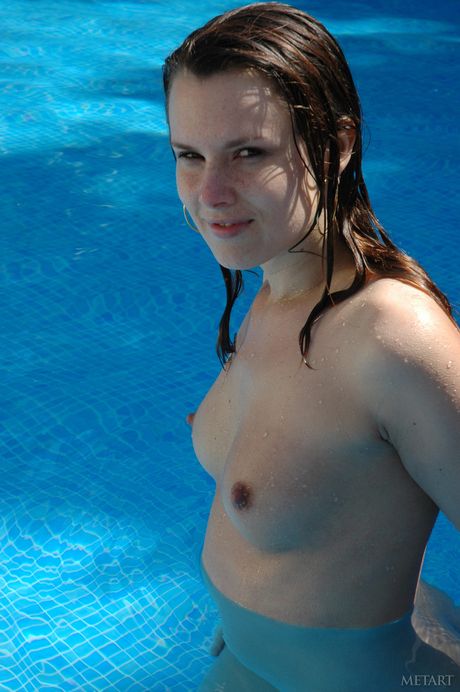 Brunette teen Stefany A poses naked in a field and in a swimming pool