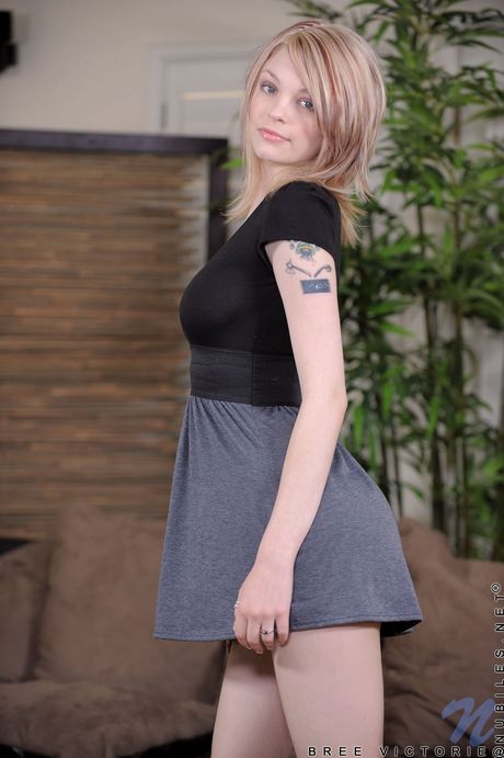 Blonde girl Bree Victorie removes a dress and heels before masturbating