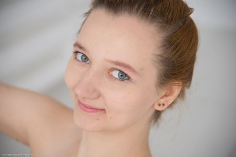 Young brunette Ena models totally naked in a ball chair during solo action