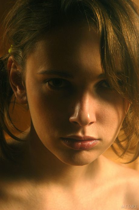 Svelte teen Olya M strips and poses nude in a solo shoot