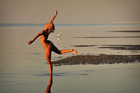 The Life Erotic: Blonde teen Marilyn Winters models totally naked on a rocky beach