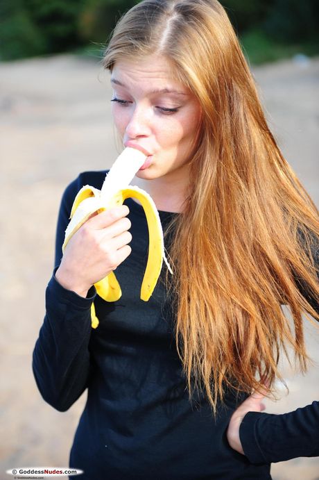 Natural redhead Indi models totally naked on a blanket in a field