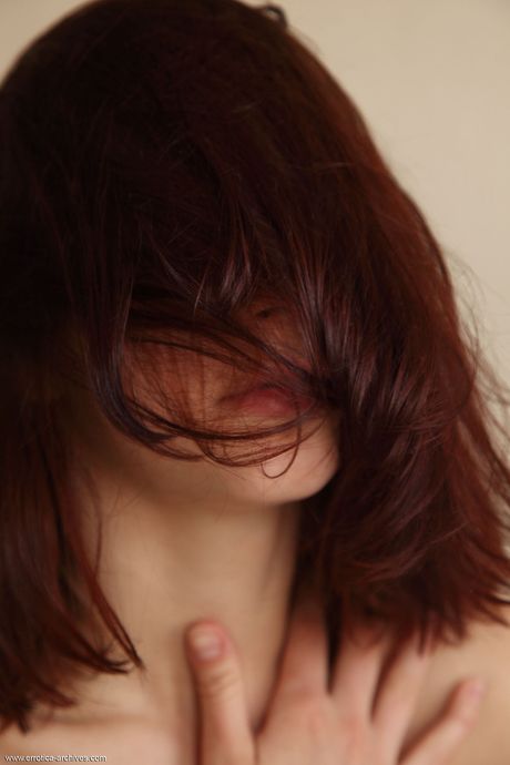 Young beauty Tigra highlights her landing strip pussy while totally naked