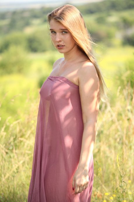 Glamour babe Beverly A flaunting her big tits and shaved pussy outdoors