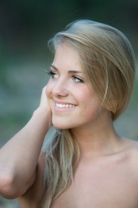 Innocent teen Sharon A models totally naked on a blanket in a field