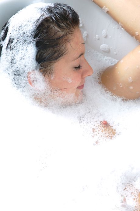 Adorable teen Alisia gets naked in a bathtub while washing her hair