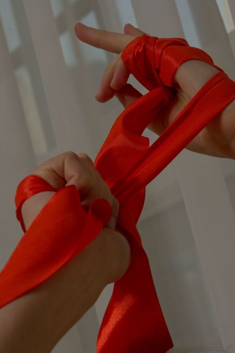 Beautiful teen Juliet J fingers her pussy while wearing a see thru top