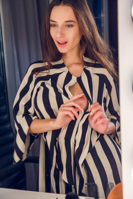 Gloria Sol takes off her red dress and panties and starts to masturbate