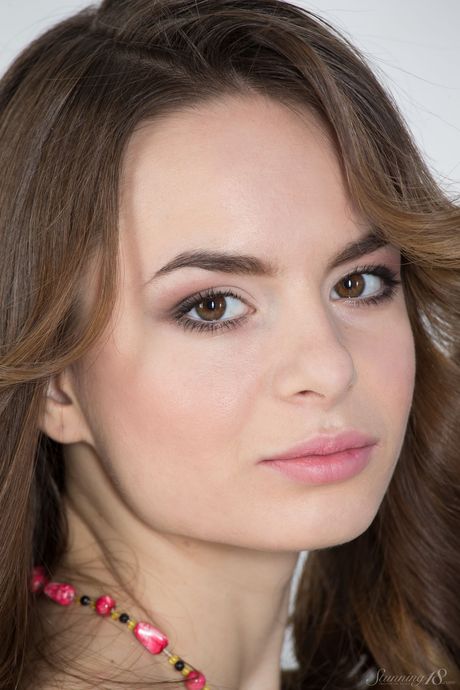 Naked teen Amy spreads her long legs wide open to showcase her shaved pussy