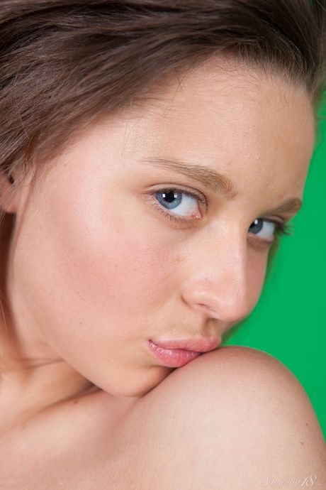 Brunette teen Pamela D holds a bunch of grapes while posing in the nude