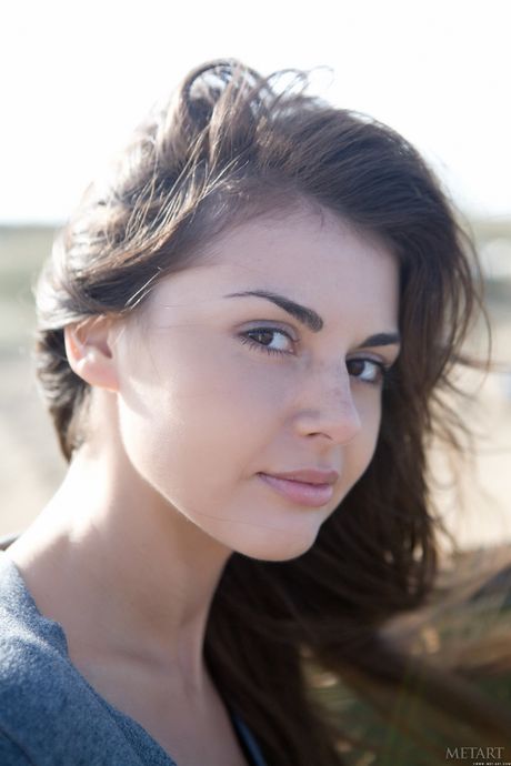 Astrud A confidently presents her nubile body as she poses on the beach