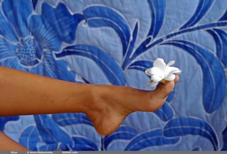 Sexy redhead Ellyn poses naked in the garden to show her tiny tits and ass