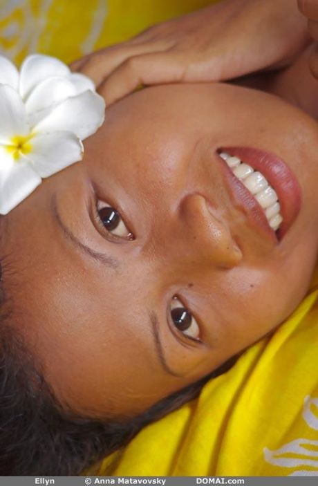 Sexy redhead Ellyn poses naked in the garden to show her tiny tits and ass