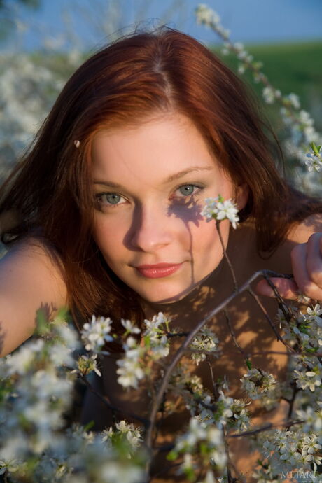 Slender teen Indiana A bares it all in the garden & presents her big tits & ass