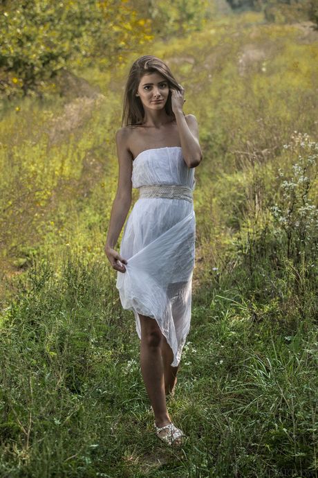 Thin teen Sunshine A shows her tiny tits and bald pussy in the nude