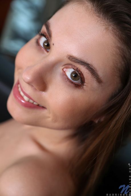 Winsome teen Sabrisse shows her small tits and trimmed vagina in a window