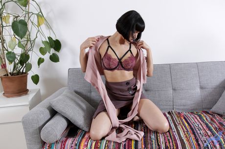 Black haired MILF Black Kat goes naked on a couch before masturbating