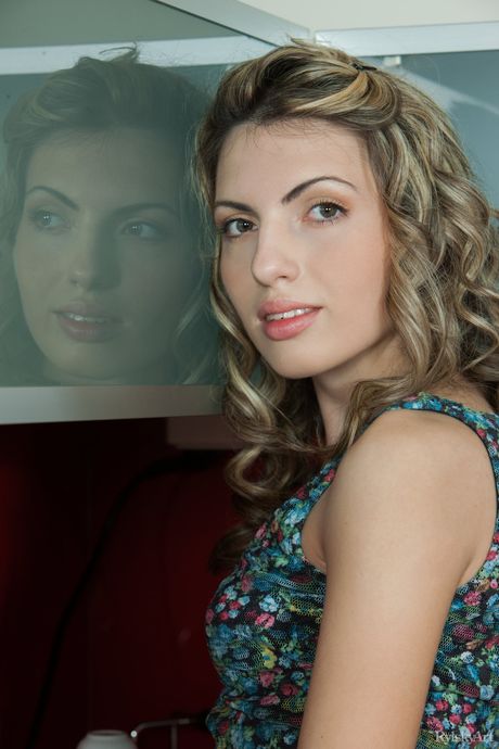 Young brunette Maggie gets completely naked on a kitchen counter