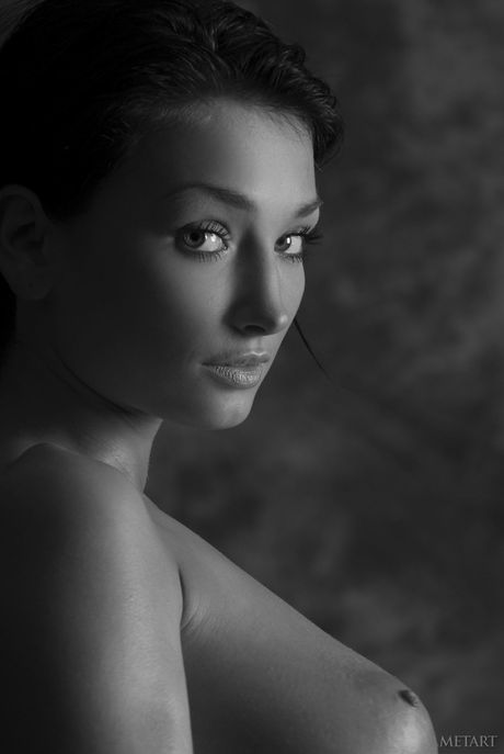 Charming teen Anna AP removes her bikini and oils her body in the nude