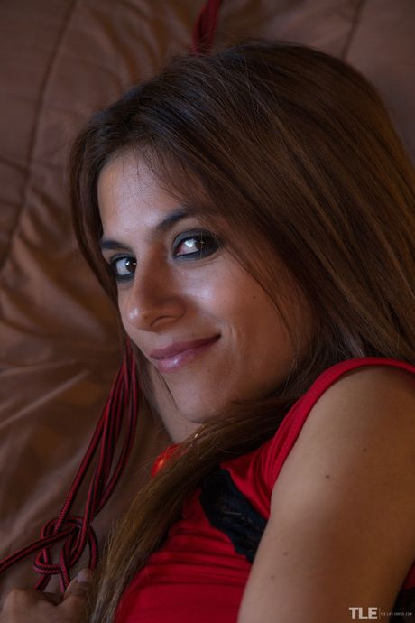 Angelic teen Paloma D removes a red dress before toying her pussy with a dildo