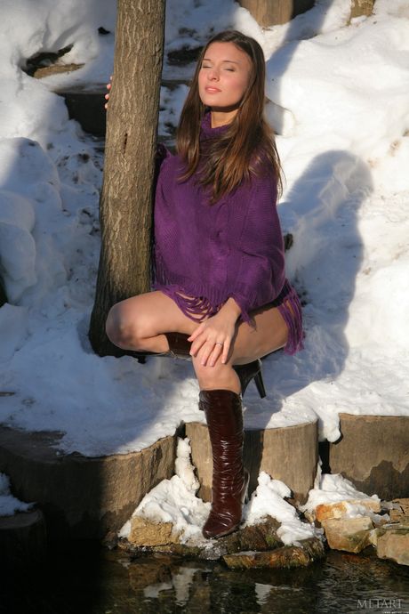 Beautiful teen Izabelle A goes naked in boots on snowy stairs