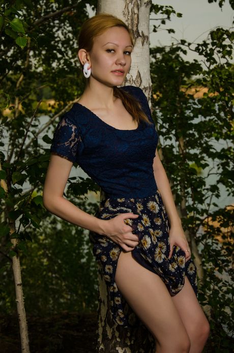 Sexy redhead Anna B gets tied up in a forest before masturbating