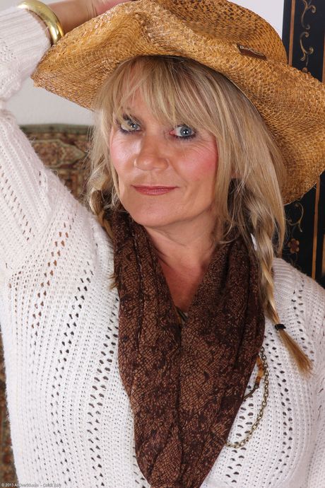 Mature blonde Sherri Donovan parts her pussy in cowgirl boots