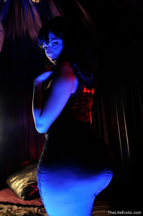 Attractive teen Ava shows off her tattooed body and poses naked on her bed