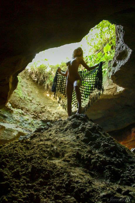 Blonde teen Quinby B poses completely naked in a sinkhole