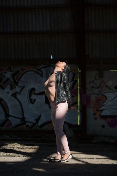 Sexy babe Veronica Snezna strips naked and poses in handcuffs outdoors