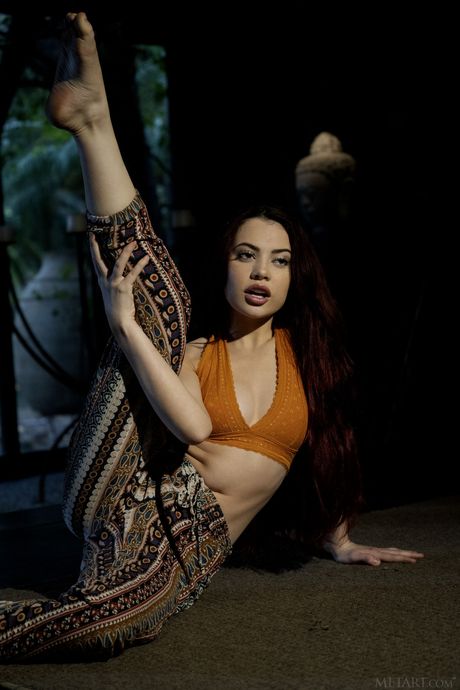 Lean teen Sabina Rouge gets naked in a yoga pose after stretching