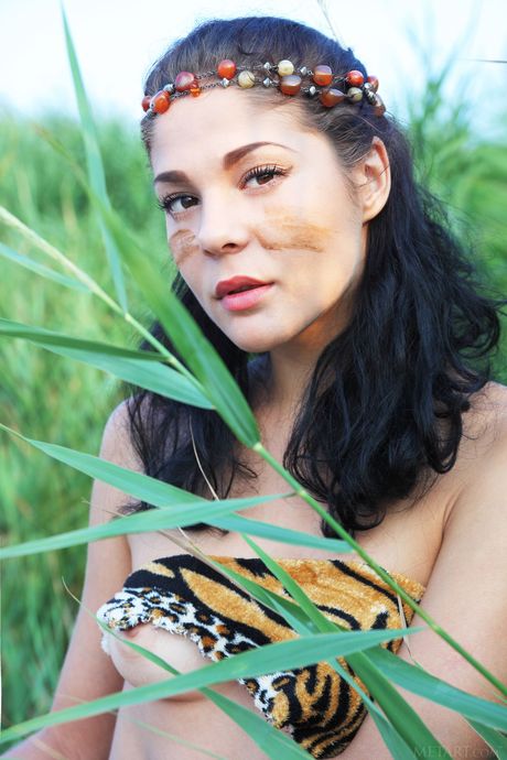 Attractive teen Callista B removes her lingerie and poses nude on a rocky beach