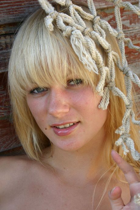 Blonde teen Valya B models totally naked in a confident fashion by herself