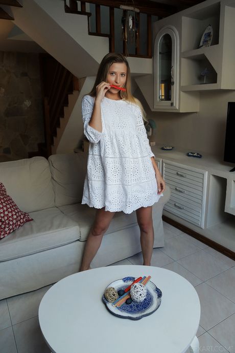 Young redhead Lisa Dawn toys her pussy after getting naked