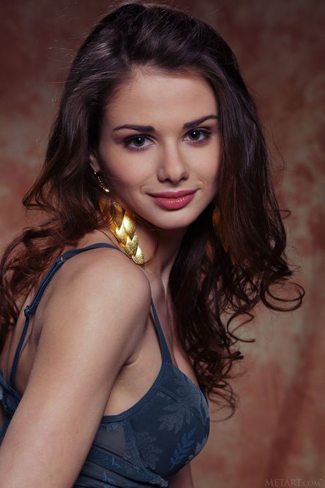 Sexy brunette Loretta A removes her lingerie and high heels to pose nude