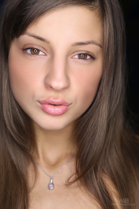 Cute teen Maria shows her small tits and exhibits her bald pussy in a solo