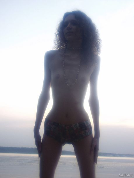 Skinny teenage babes posing naked on the beach and showing their holes