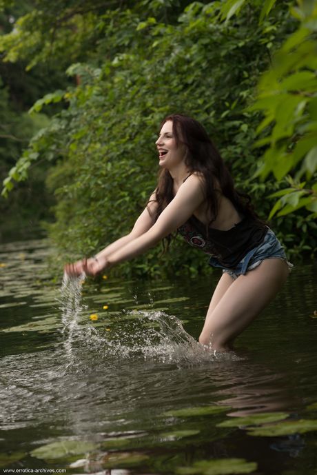 Svelte teen Leda strips and poses nude on a bench by the river