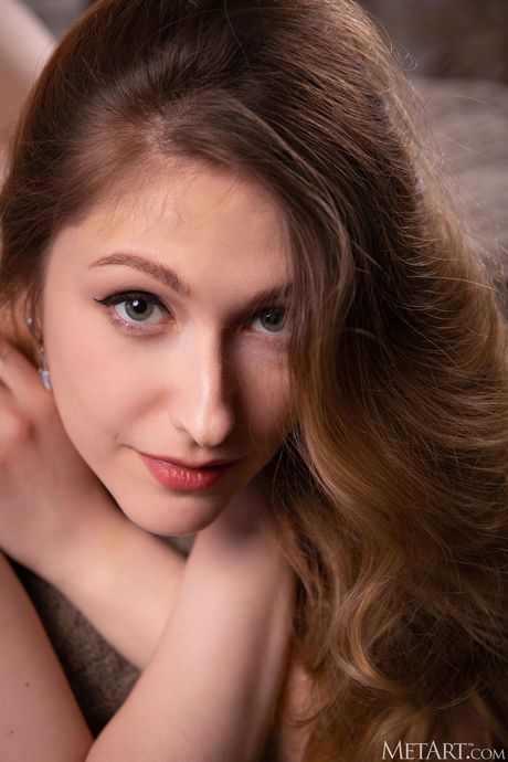 Blonde teen Katty Muss gets completely naked on a bed enticingly