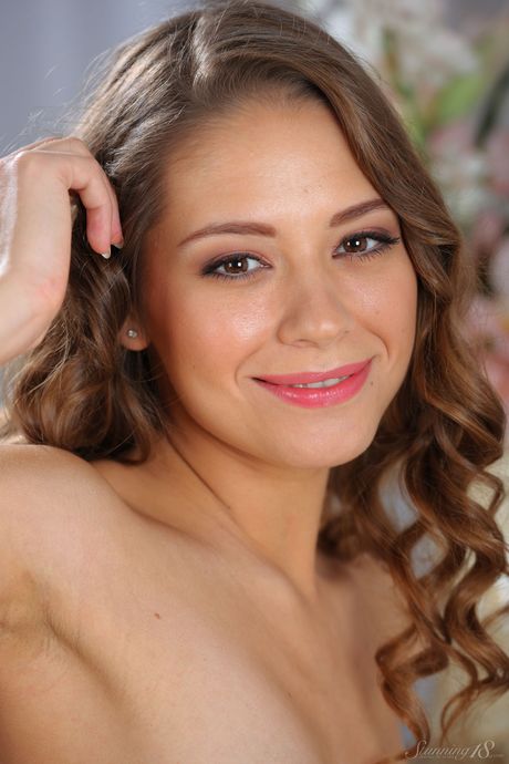 Lovely teen Cassandra shows her tiny tits and shaved pussy in the nude