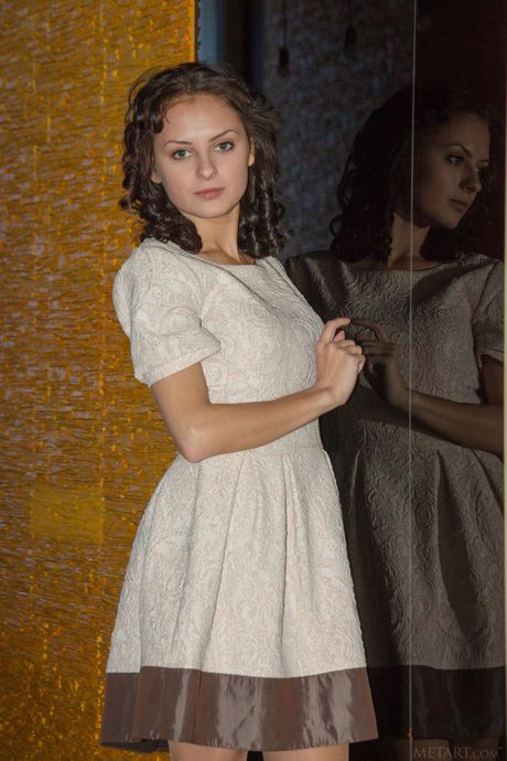 Pretty teen Karina Voss removes a crocheted dress to get naked