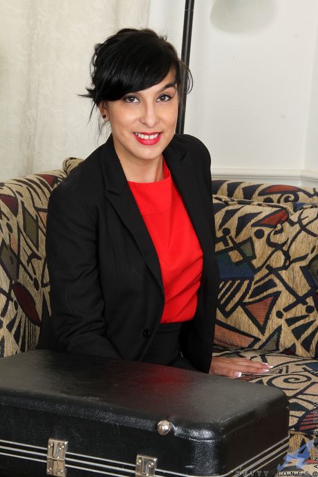 Brunette MILF Betty Jones toys her hairy pussy in a sexy striptease