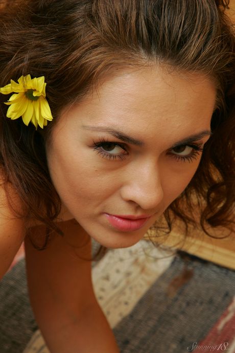 Young girl with long hair Audrey fingers her pussy while completely naked