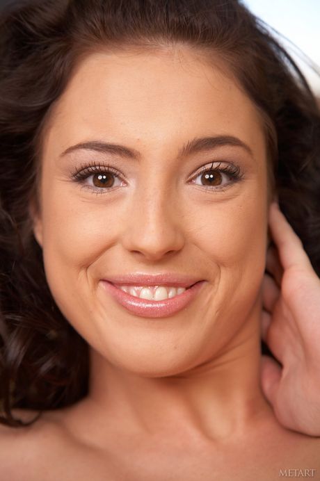 Dark haired teen Bijou A removes her lingerie to pose nude