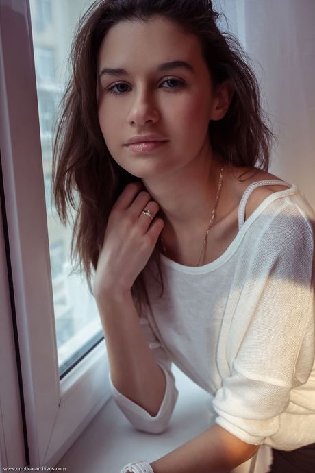 Pretty teen Cristin removes her underwear to get totally naked in a bedroom