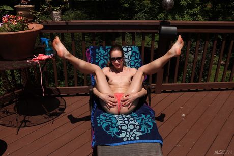 Naked teen Nadia Noja removes her bikini to pose nude in a backyard