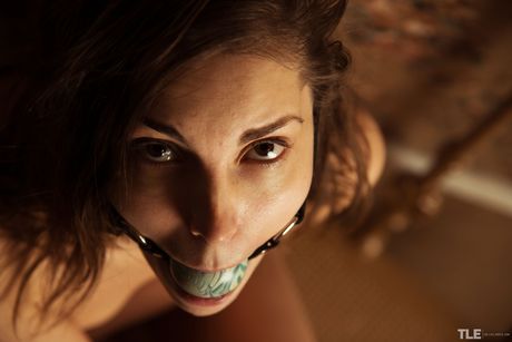 Brunette teen Mila H masturbates with a jump rope in a ball gag